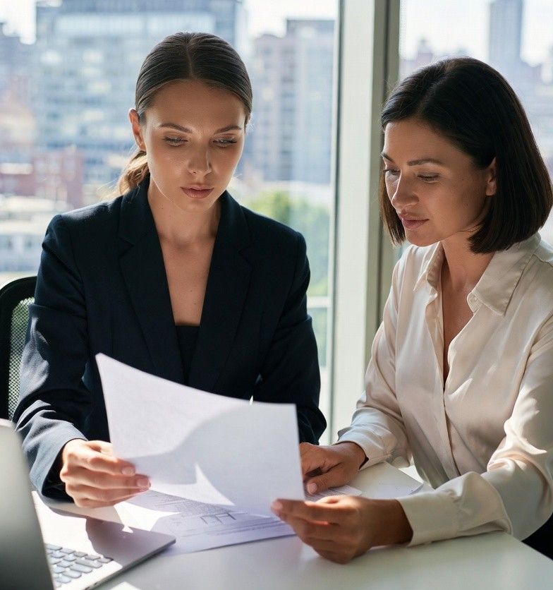 Women professionals reviewing property investment plans